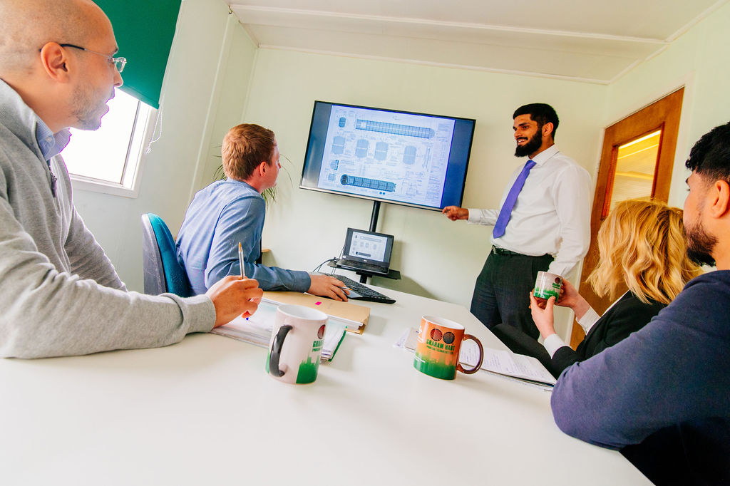 Image of Graham Hart engineers around a meeting table